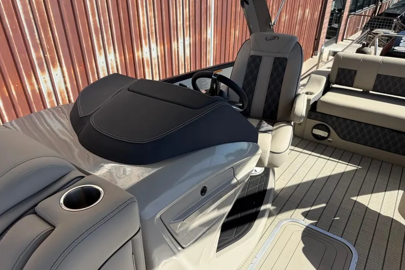 Slide: The Image of 2022 Barletta L23UCA boat interior with steering wheel and seating, showcasing luxury design. - 17