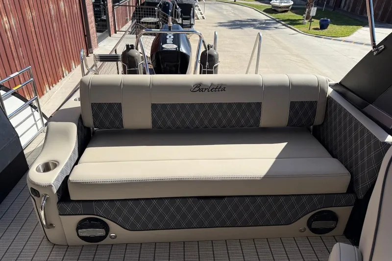 Slide: The Image of 2022 Barletta L23UCA boat interior with cushioned seating and cup holder. - 19