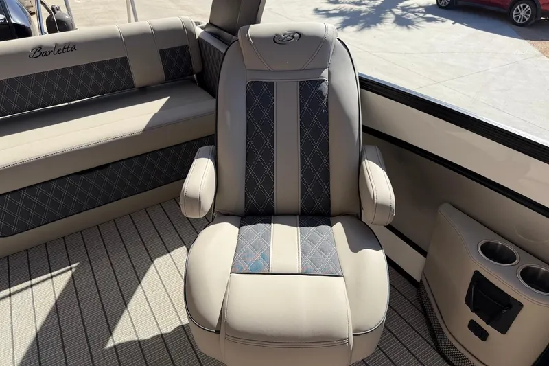 Slide: The Image of 2022 Barletta L23UCA boat interior with luxurious seating and cup holders. - 20