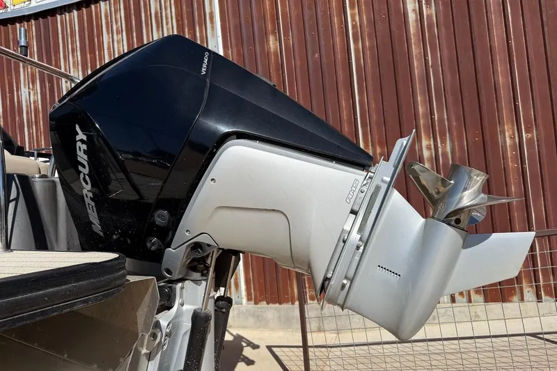 Slide: The Image of 2022 Barletta L23UCA boat with Mercury outboard motor, displayed outdoors. - 4