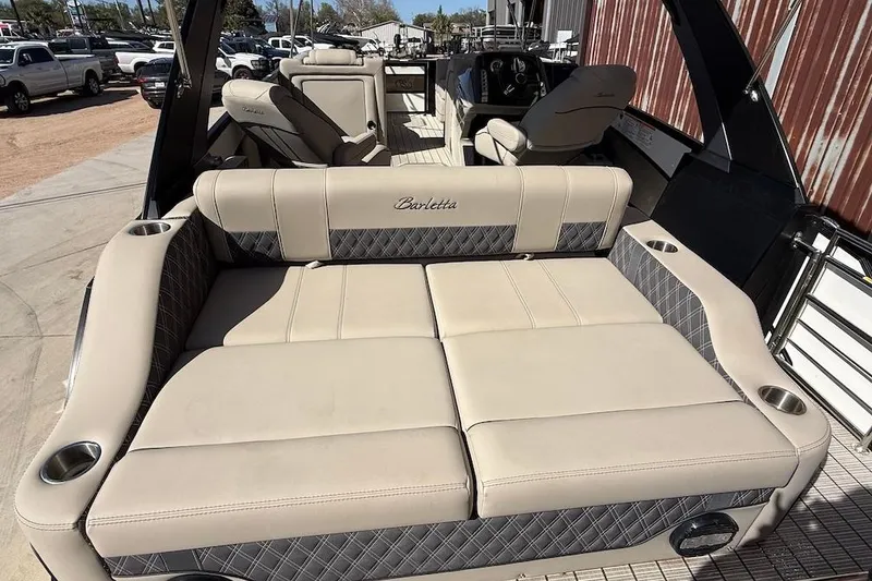 Slide: The Image of 2022 Barletta L23UCA pontoon boat with beige seating and cup holders. - 6