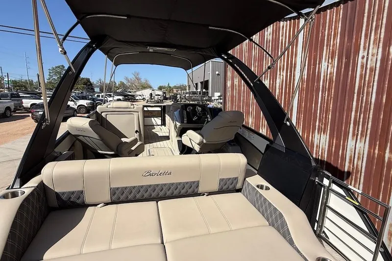 Slide: The Image of 2022 Barletta L23UCA pontoon boat interior with beige seating and canopy. - 7