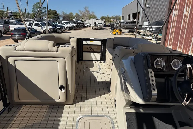Slide: The Image of 2022 Barletta L23UCA pontoon boat interior with beige seating and modern dashboard. - 8