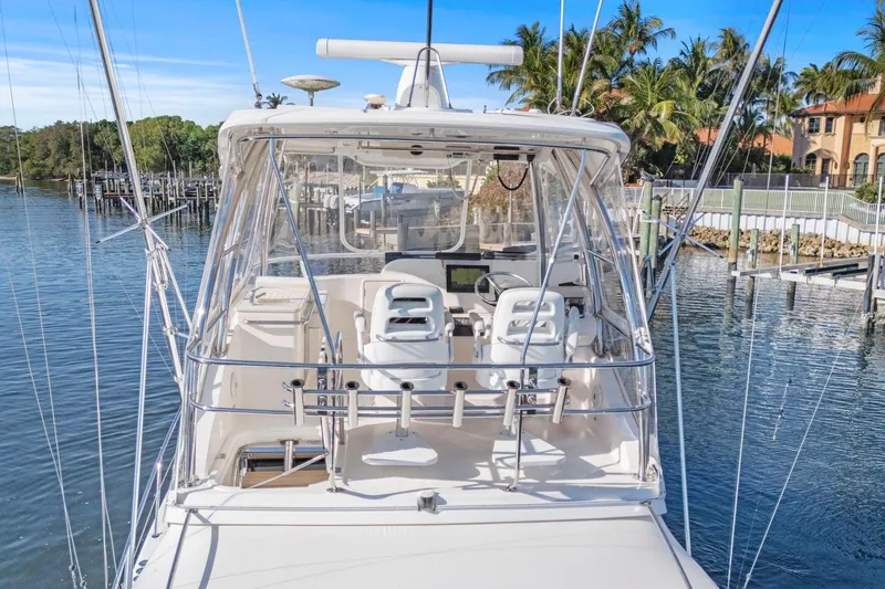 Slide: The Image of 2016 Riviera 43 Open Flybridge yacht docked in a scenic marina setting. - 11