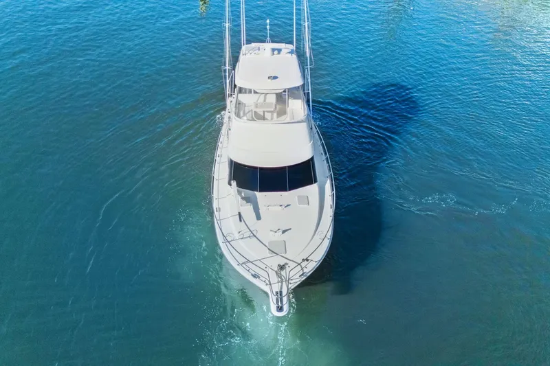 Slide: The Image of 2016 Riviera 43 Open Flybridge yacht cruising on clear blue water. - 13
