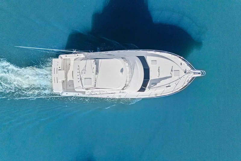 Slide: The Image of Aerial view of 2016 Riviera 43 Open Flybridge yacht cruising on blue water. - 2
