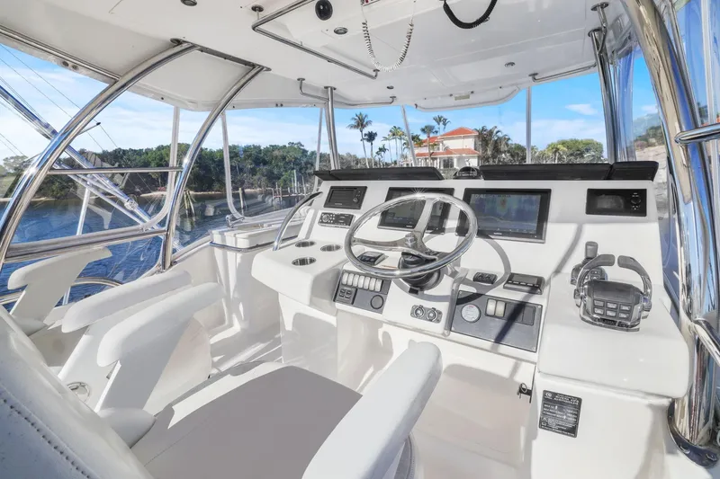 Slide: The Image of 2016 Riviera 43 Open Flybridge helm with modern controls and panoramic view. - 21