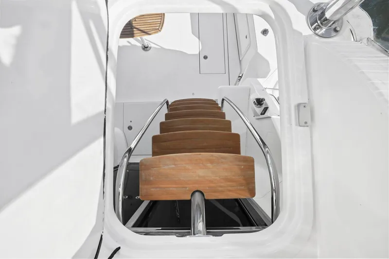 Slide: The Image of Staircase on 2016 Riviera 43 Open Flybridge yacht with wooden steps and metal railings. - 24
