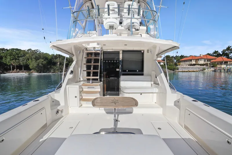 Slide: The Image of 2016 Riviera 43 Open Flybridge yacht with spacious deck and scenic waterfront view. - 25