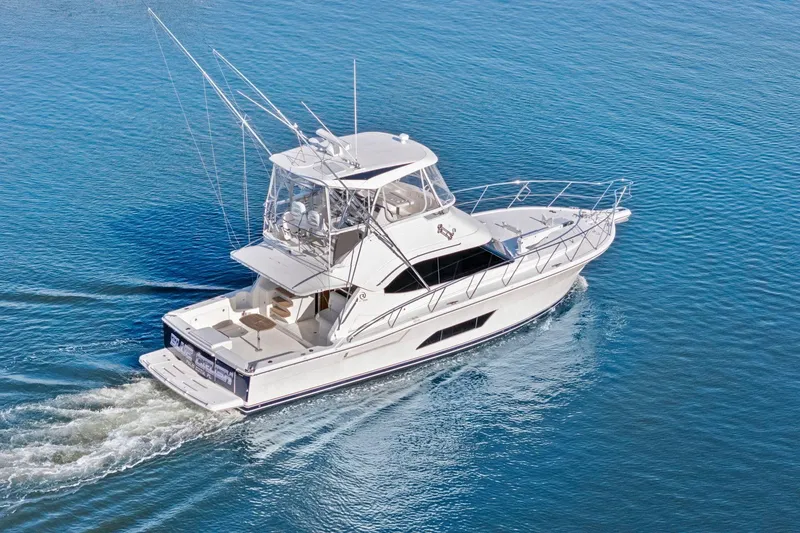 Slide: The Image of 2016 Riviera 43 Open Flybridge yacht cruising on calm blue waters. - 3