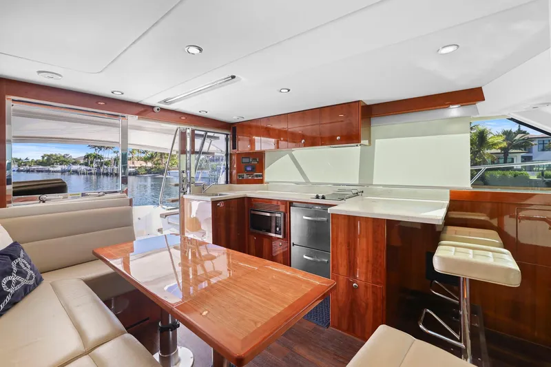 Slide: The Image of Luxurious interior of 2016 Riviera 43 Open Flybridge yacht with modern kitchen and seating area. - 31
