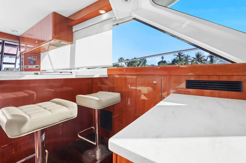 Slide: The Image of Luxurious interior of 2016 Riviera 43 Open Flybridge yacht with modern seating and wood finish. - 36