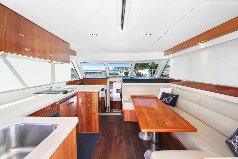 Slide: The Image of Luxurious interior of 2016 Riviera 43 Open Flybridge yacht with modern kitchen and seating area. - 37