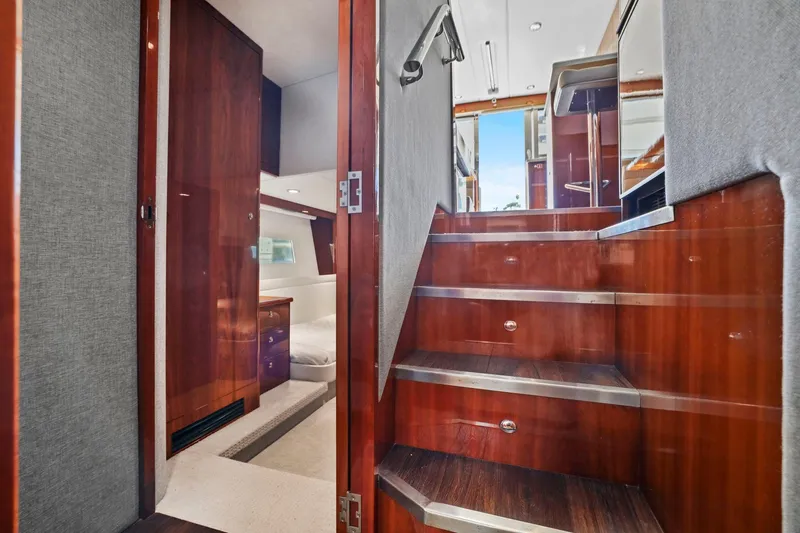 Slide: The Image of Interior view of 2016 Riviera 43 Open Flybridge yacht, featuring wooden stairs and cabin entrance. - 38