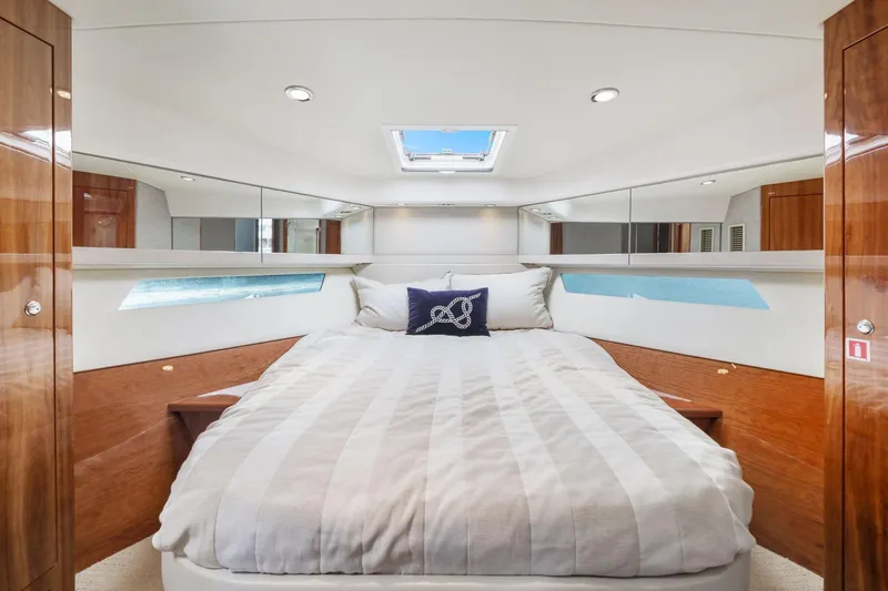 Slide: The Image of Luxurious bedroom interior of 2016 Riviera 43 Open Flybridge yacht with skylight and wood accents. - 39