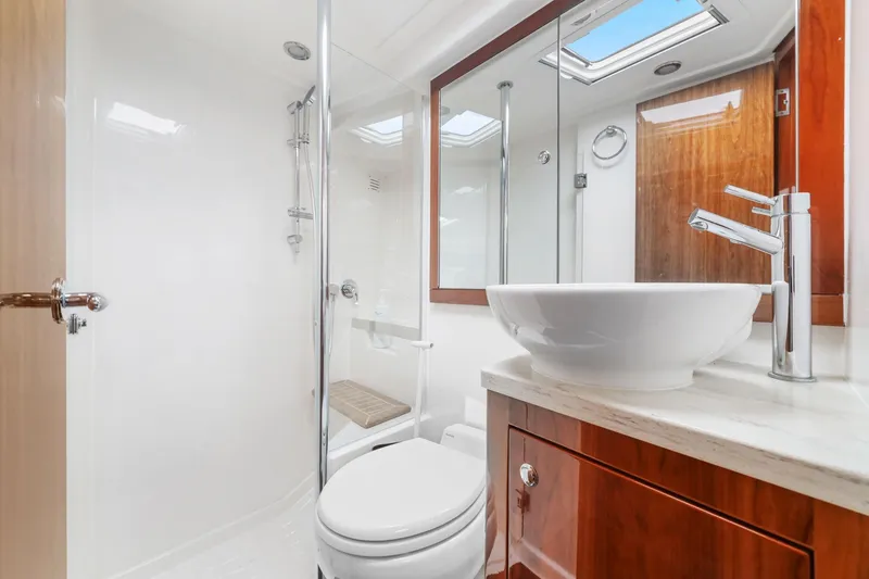 Slide: The Image of Luxurious bathroom in 2016 Riviera 43 Open Flybridge yacht with modern fixtures and elegant design. - 45