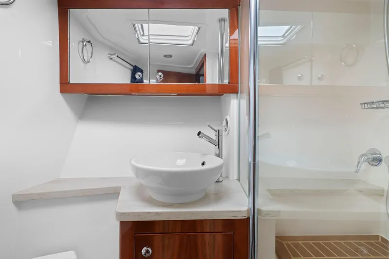 Slide: The Image of Luxurious bathroom in 2016 Riviera 43 Open Flybridge yacht with modern sink and shower. - 47