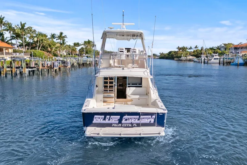 Slide: The Image of 2016 Riviera 43 Open Flybridge yacht cruising in a scenic marina. - 5