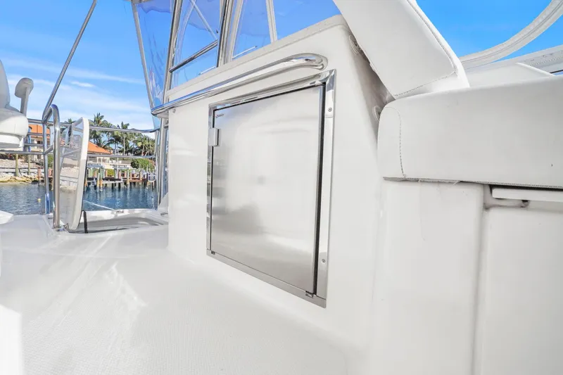 Slide: The Image of 2016 Riviera 43 Open Flybridge yacht deck with stainless steel door and ocean view. - 51