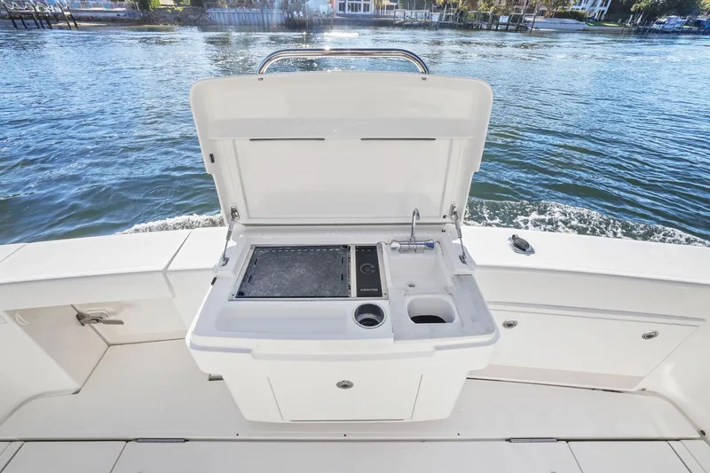Slide: The Image of Riviera 43 Open Flybridge 2016 boat with outdoor sink and grill on deck. - 56