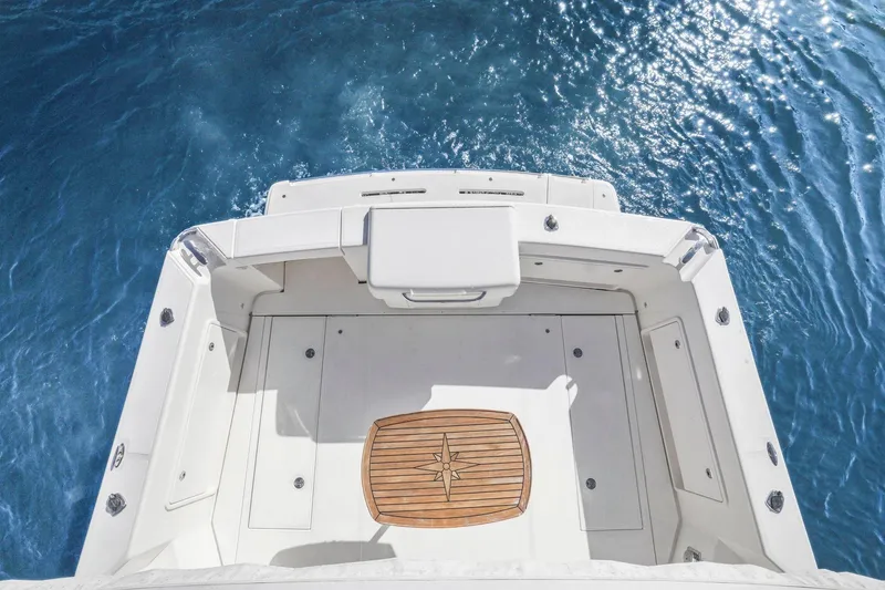 Slide: The Image of 2016 Riviera 43 Open Flybridge boat deck overlooking blue ocean water. - 57