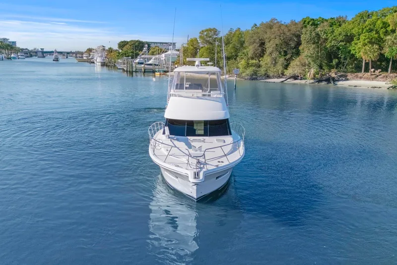 Slide: The Image of 2016 Riviera 43 Open Flybridge yacht cruising in a serene waterway. - 9