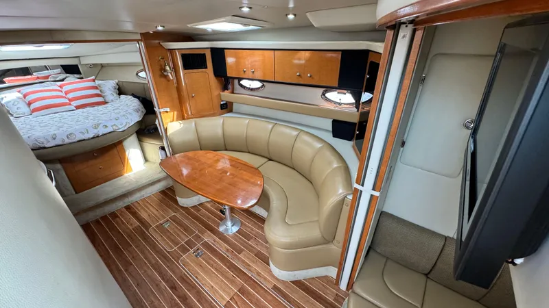 Slide: The Image of Interior of a 2007 Chaparral Signature 350 yacht with leather sofa and wooden table. - 46