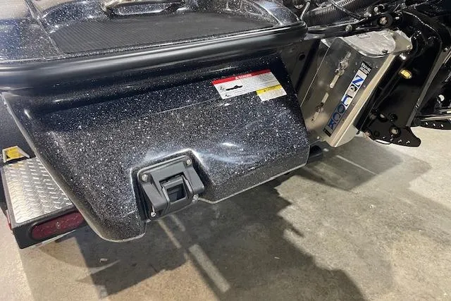 Slide: The Image of 2027 Caymas 201 Pro boat rear view with metallic finish and motor details. - 10