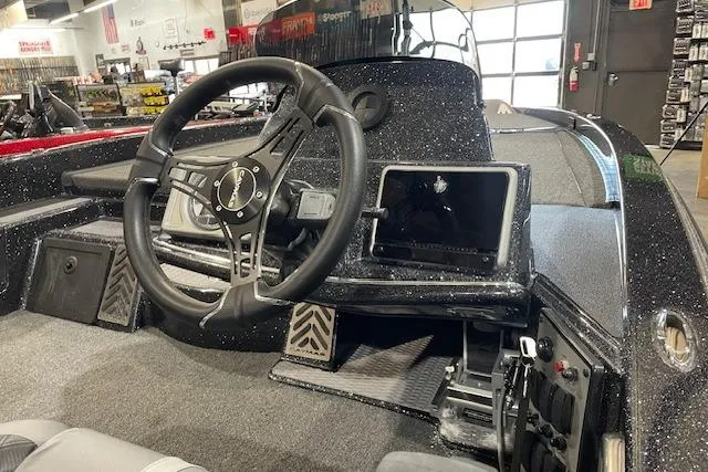 Slide: The Image of 2027 Caymas 201 Pro boat interior with steering wheel and dashboard display. - 4