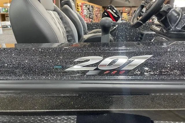 Slide: The Image of 2027 Caymas 201 Pro boat interior with logo detail and steering wheel. - 5