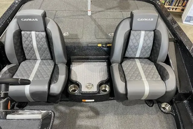 Slide: The Image of 2027 Caymas 201 Pro boat interior with two gray seats and cup holders. - 6