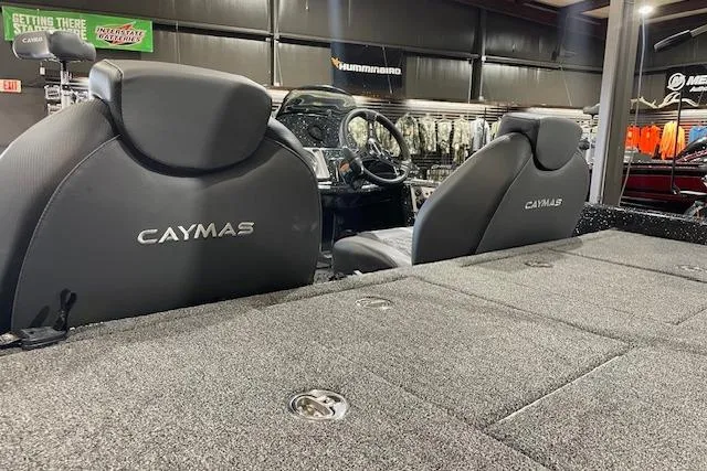Slide: The Image of 2027 Caymas 201 Pro boat interior with branded seats and carpeted deck. - 9