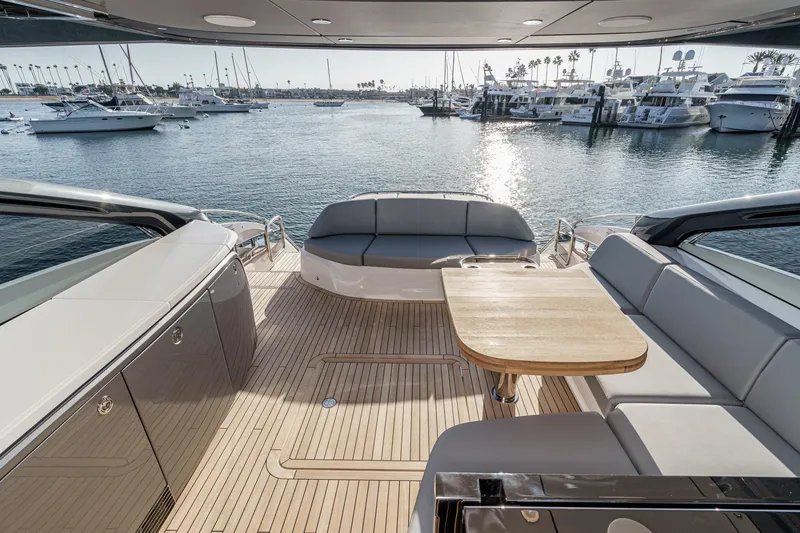Slide: The Image of Luxurious 2026 Princess V55 yacht deck with elegant seating and scenic marina view. - 11