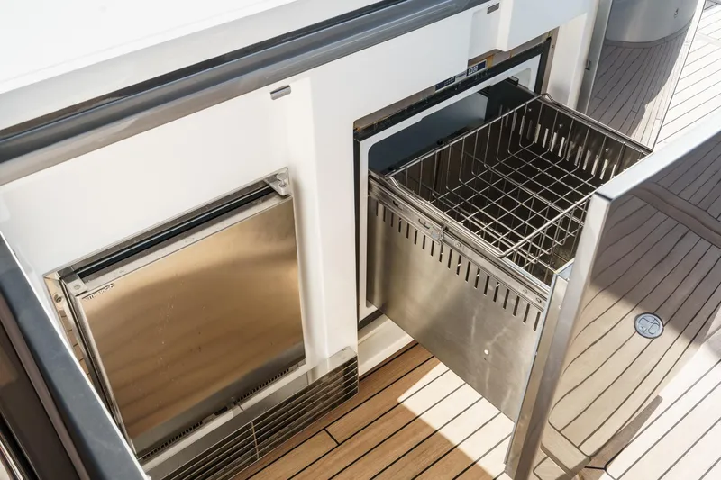 Slide: The Image of Stainless steel drawer on 2026 Princess V55 yacht, featuring sleek design and wooden deck. - 16