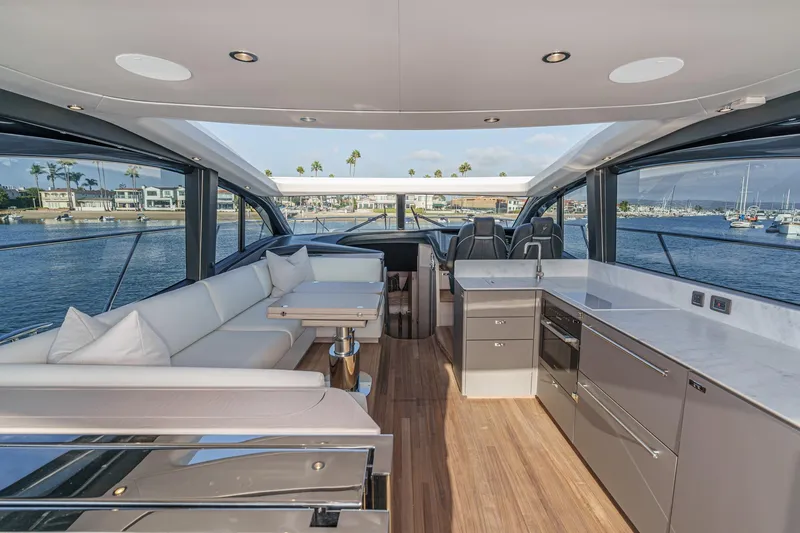 Slide: The Image of Luxurious 2026 Princess V55 yacht interior with modern kitchen and seating area. - 19