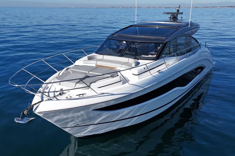 Slide: The Image of 2026 Princess V55 yacht cruising on calm blue waters. - 2