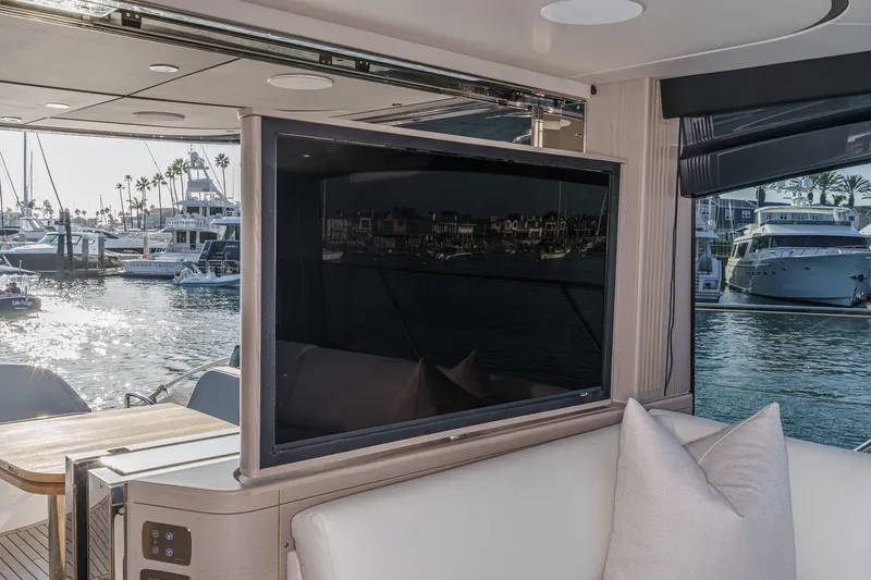 Slide: The Image of Interior view of 2026 Princess V55 yacht with marina backdrop. - 24