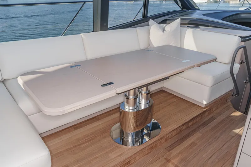 Slide: The Image of Luxurious interior of 2026 Princess V55 yacht with elegant seating and modern table design. - 28