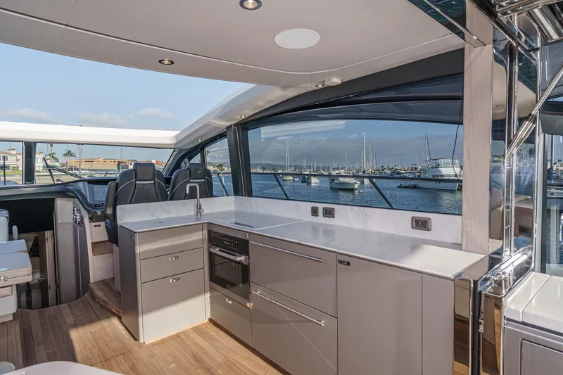 Slide: The Image of Luxurious 2026 Princess V55 yacht interior with modern kitchen and scenic marina view. - 29