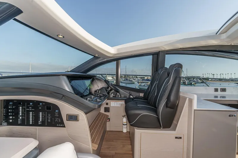 Slide: The Image of Interior view of 2026 Princess V55 yacht cockpit with modern controls and seating. - 33