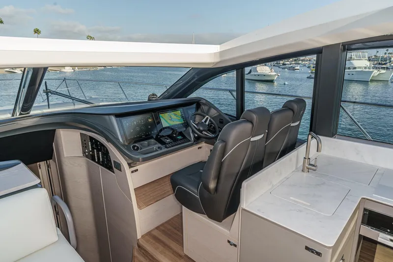 Slide: The Image of Interior of 2026 Princess V55 yacht with modern helm and luxurious seating. - 34