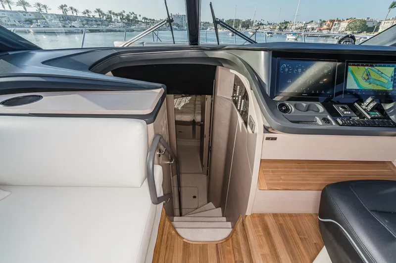 Slide: The Image of Interior of 2026 Princess V55 yacht with modern dashboard and staircase. - 36