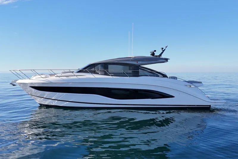 Slide: The Image of 2026 Princess V55 yacht on calm sea under clear blue sky. - 4