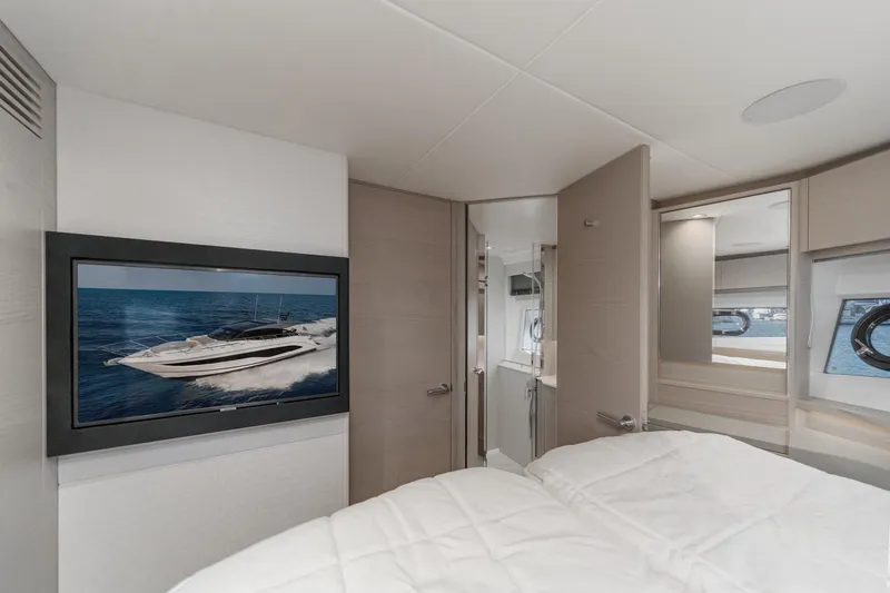 Slide: The Image of Luxurious interior of 2026 Princess V55 yacht with modern bedroom and TV display. - 45