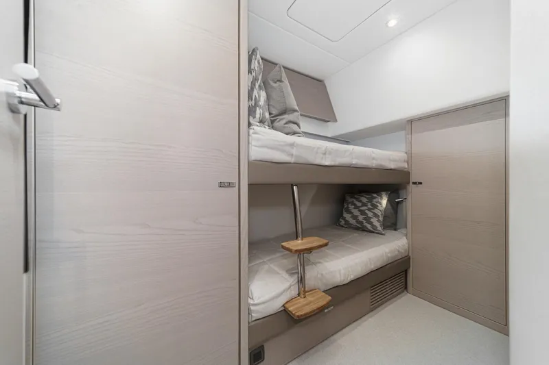Slide: The Image of Modern bunk bed cabin in 2026 Princess V55 yacht, featuring sleek design and cozy bedding. - 47
