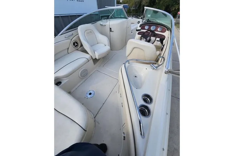 Slide: The Image of 2008 Sea Ray 240 Sundeck boat interior with white seating and dashboard. - 3