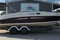 Slide: The Image of 2008 Sea Ray 240 Sundeck boat on trailer outside a building. - 4