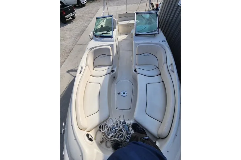 Slide: The Image of 2008 Sea Ray 240 Sundeck boat interior with white seating and windshield. - 5