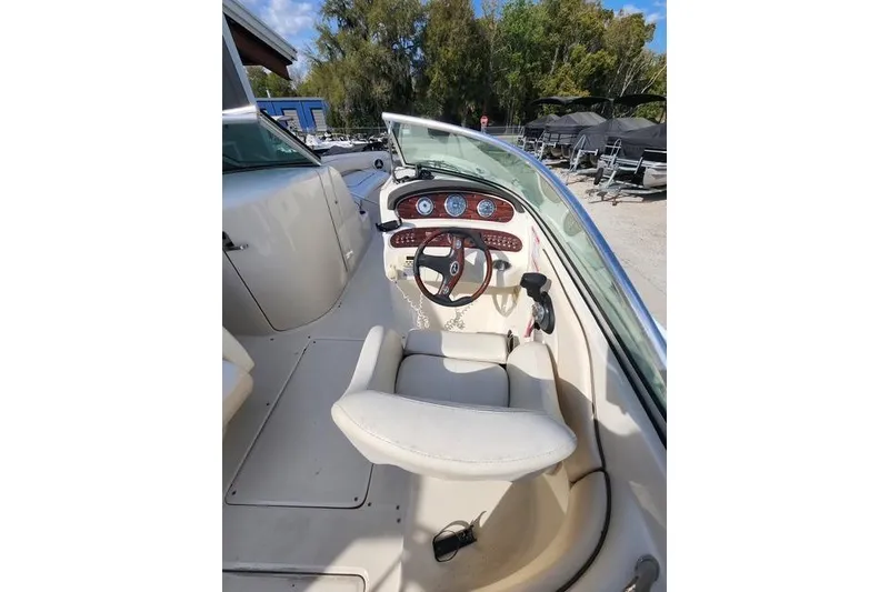 Slide: The Image of 2008 Sea Ray 240 Sundeck boat cockpit with steering wheel and dashboard controls. - 6