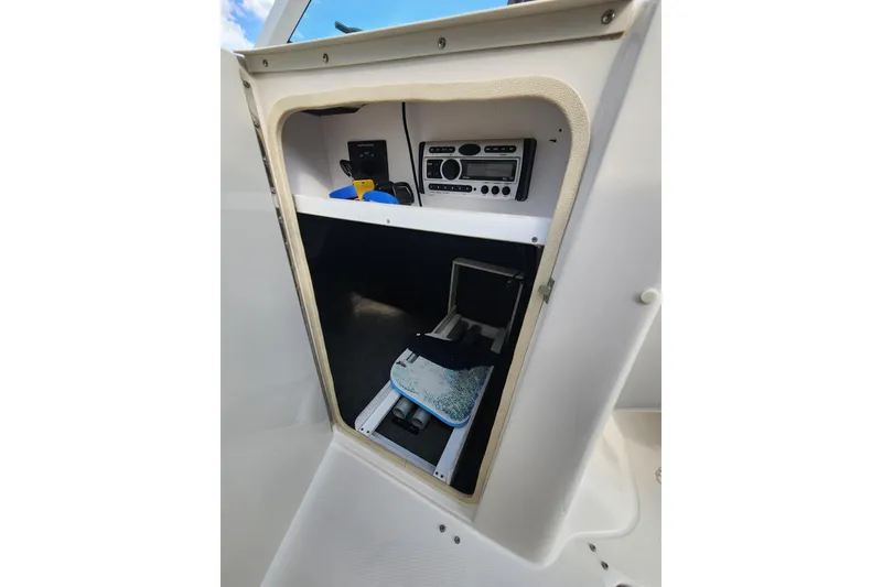 Slide: The Image of 2008 Sea Ray 240 Sundeck interior storage with stereo system and accessories. - 9